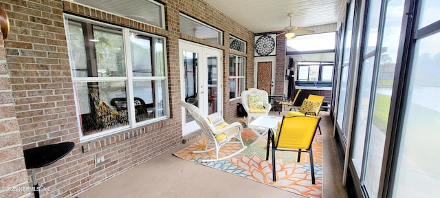 sunroom / solarium featuring ceiling fan