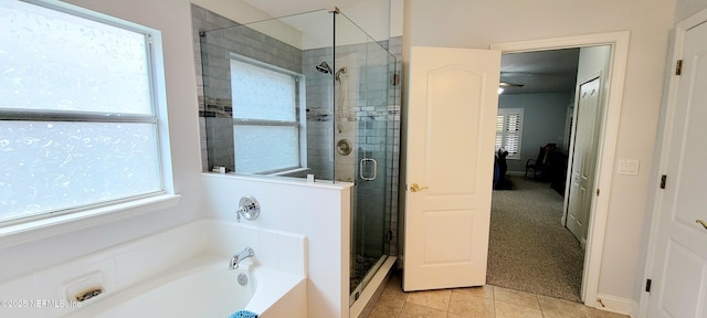 full bathroom with tile patterned floors, a shower stall, and a bath