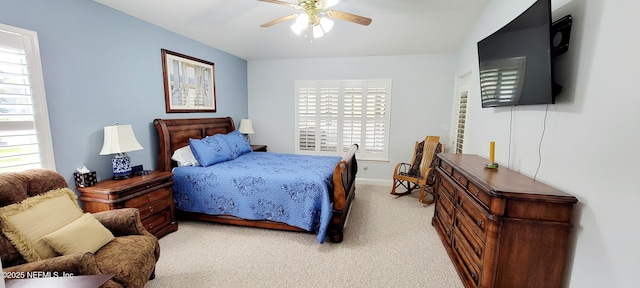 bedroom featuring a ceiling fan, light carpet, and baseboards