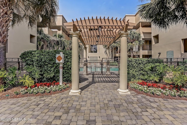 exterior space featuring fence and a pergola