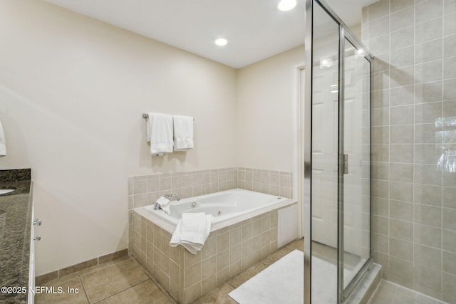 full bath featuring a stall shower, a bath, and tile patterned floors