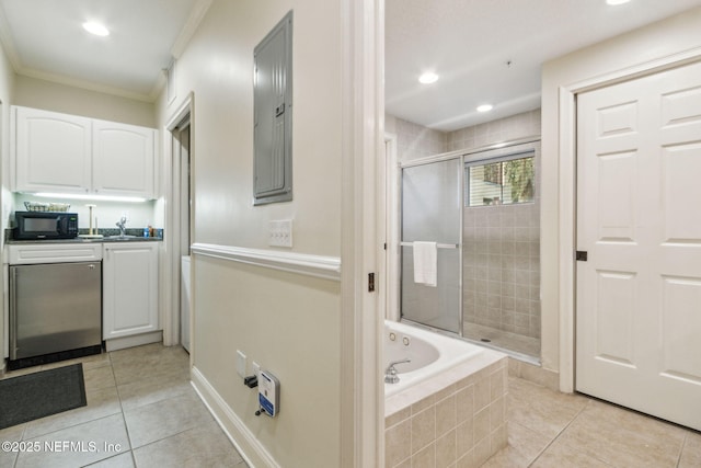 full bathroom with crown molding, a stall shower, vanity, tiled tub, and tile patterned floors