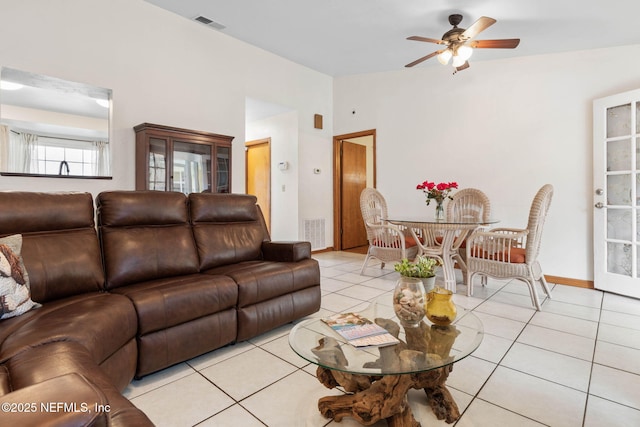 living room featuring a ceiling fan, visible vents, and light tile patterned floors