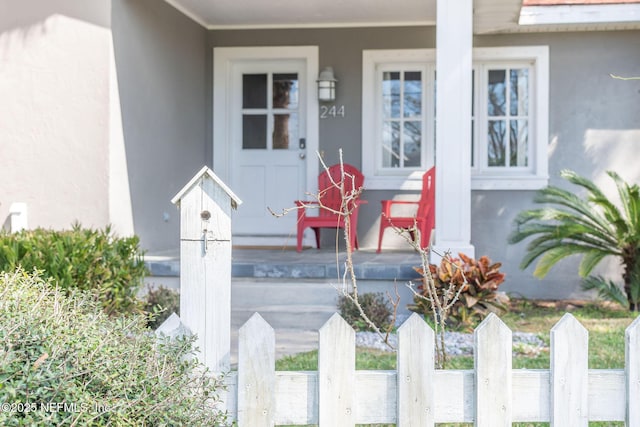 view of exterior entry featuring stucco siding