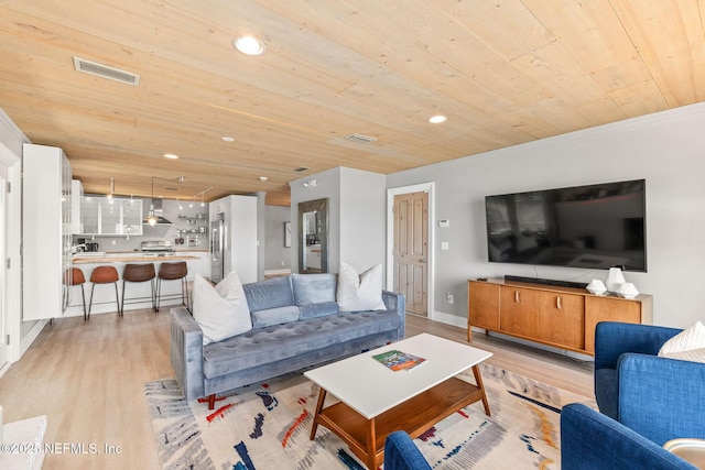 living area featuring light wood-style flooring, wooden ceiling, and visible vents