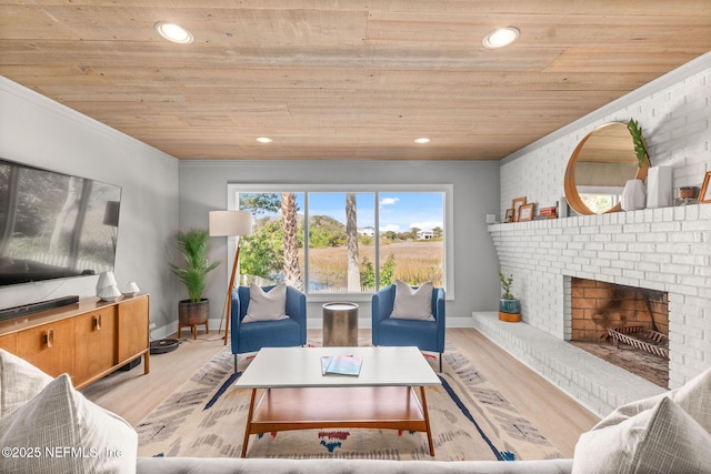 living area featuring wood ceiling, baseboards, ornamental molding, light wood-type flooring, and a brick fireplace