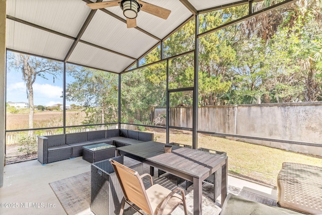 sunroom featuring vaulted ceiling and ceiling fan