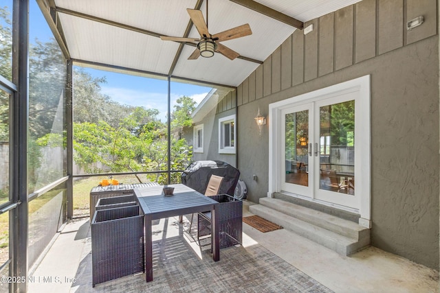 sunroom featuring vaulted ceiling and ceiling fan