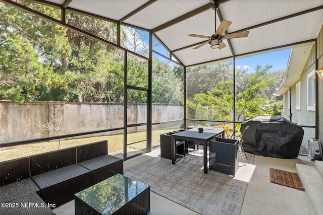 sunroom with a ceiling fan and lofted ceiling