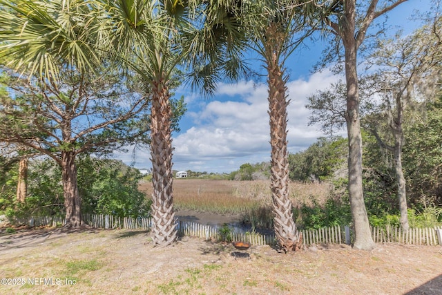 view of yard with a water view and fence