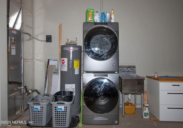 washroom featuring a sink, laundry area, stacked washer / dryer, and electric water heater