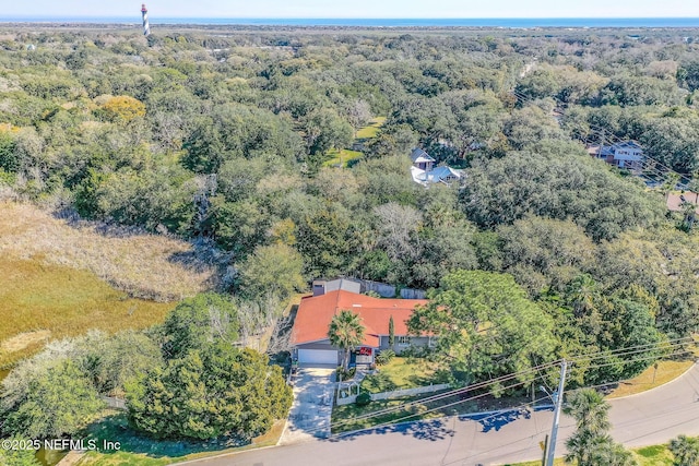 birds eye view of property with a forest view