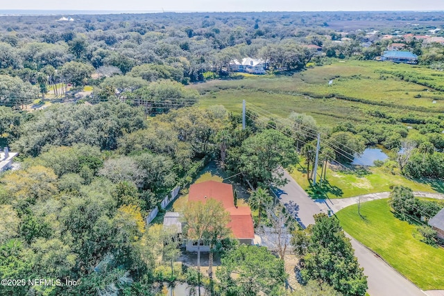 bird's eye view with a wooded view