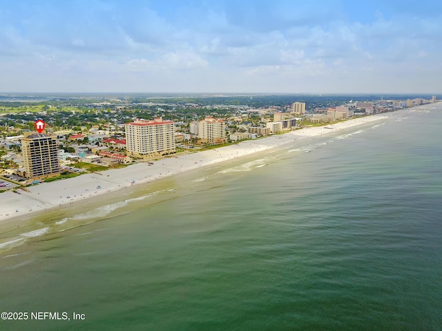 birds eye view of property with a water view, a city view, and a view of the beach