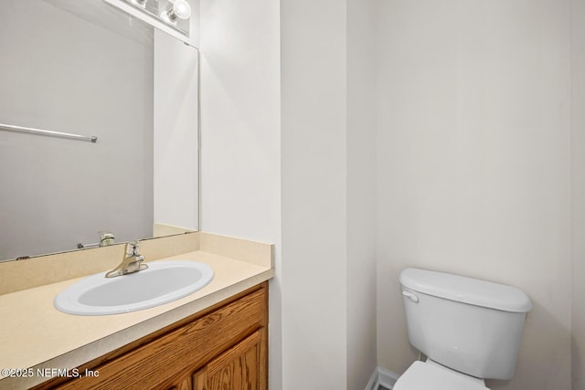 half bathroom featuring toilet and vanity