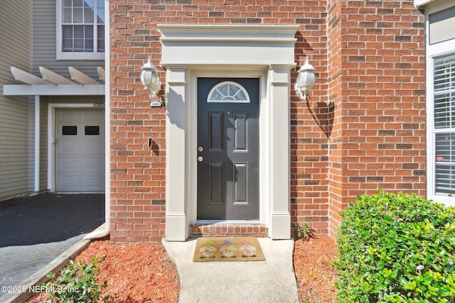 doorway to property with brick siding