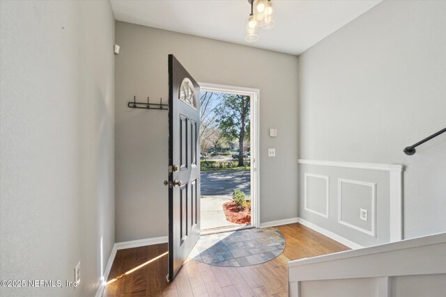 foyer with baseboards and wood finished floors