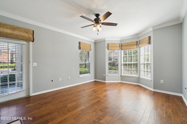 unfurnished room with ceiling fan, crown molding, baseboards, and wood finished floors