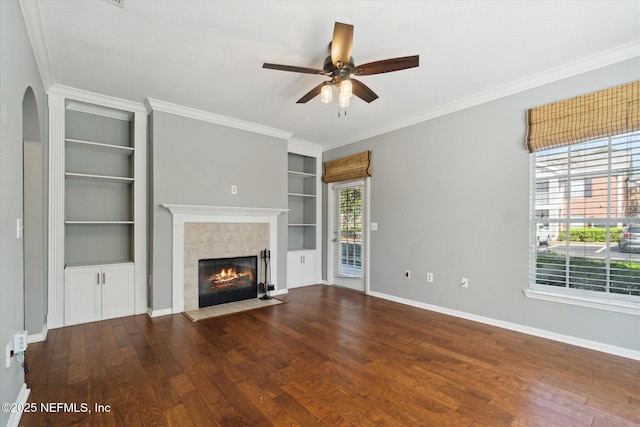 unfurnished living room featuring a fireplace, baseboards, hardwood / wood-style floors, and ornamental molding