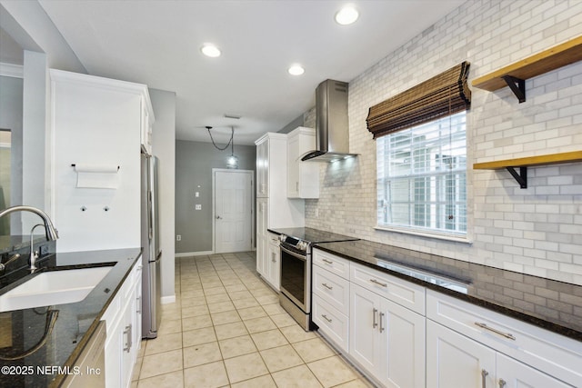 kitchen with open shelves, stainless steel appliances, tasteful backsplash, a sink, and wall chimney range hood