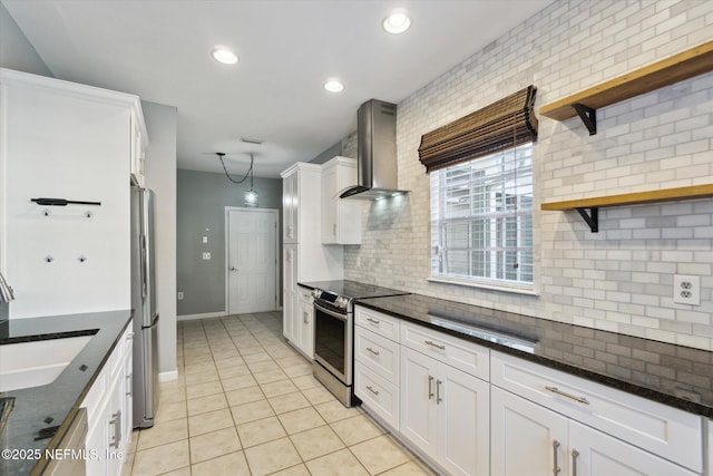 kitchen with stainless steel appliances, a sink, wall chimney range hood, open shelves, and tasteful backsplash