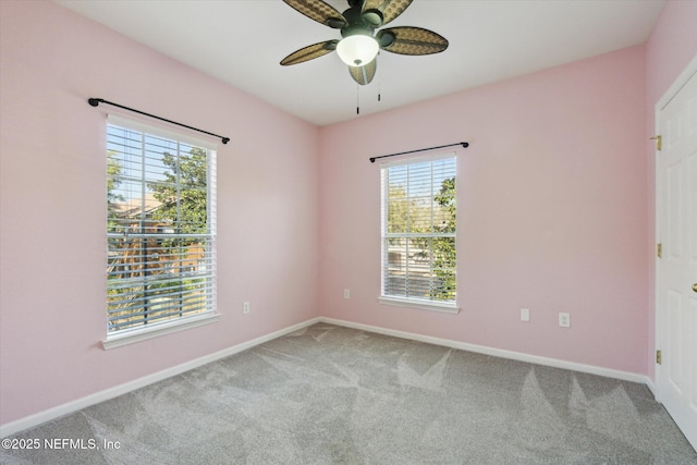 spare room with carpet floors, baseboards, and a ceiling fan