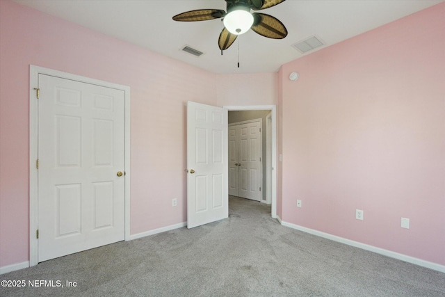 unfurnished bedroom with carpet, visible vents, ceiling fan, and baseboards