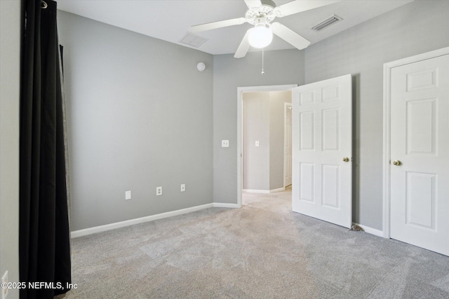 unfurnished bedroom with ceiling fan, carpet flooring, visible vents, and baseboards