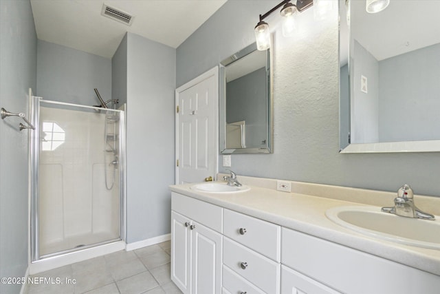 full bathroom with tile patterned floors, a sink, visible vents, and a shower stall