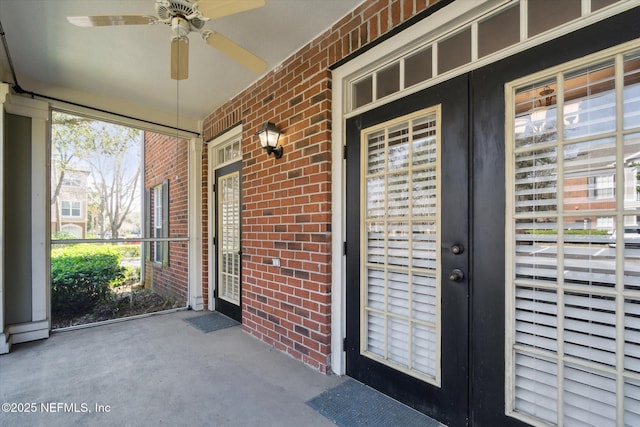 doorway to property with french doors, brick siding, and ceiling fan