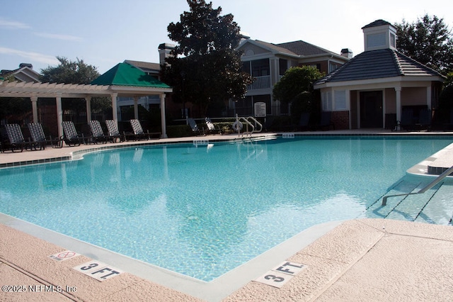 community pool with a pergola and a patio