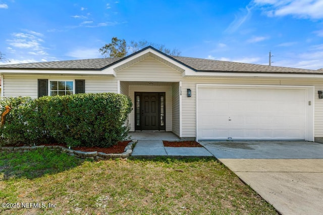 ranch-style home featuring an attached garage, a shingled roof, and concrete driveway