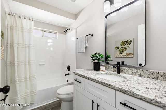 bathroom featuring toilet, wood finished floors, shower / tub combo with curtain, and vanity