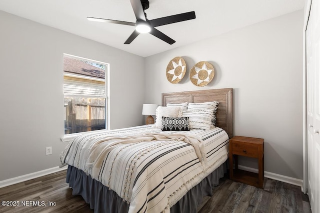 bedroom with a ceiling fan, baseboards, and wood finished floors