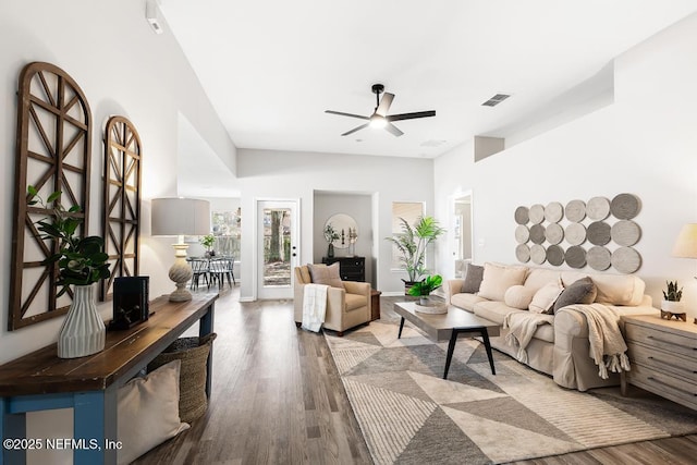 living room featuring ceiling fan, visible vents, and wood finished floors