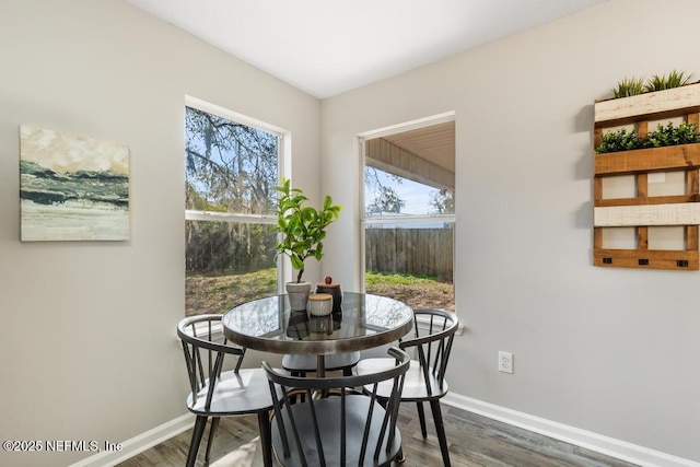 dining area with dark wood-style floors and baseboards