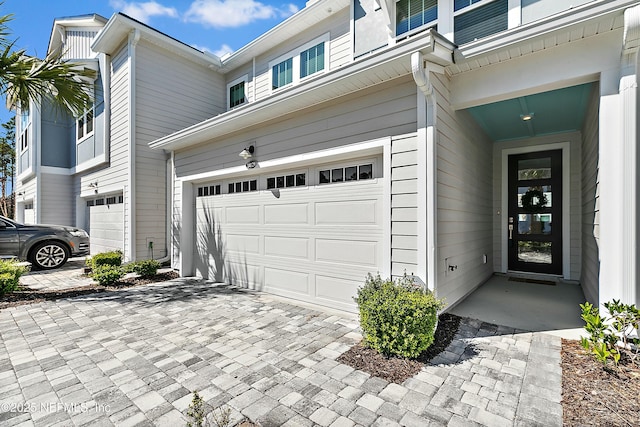 garage with decorative driveway