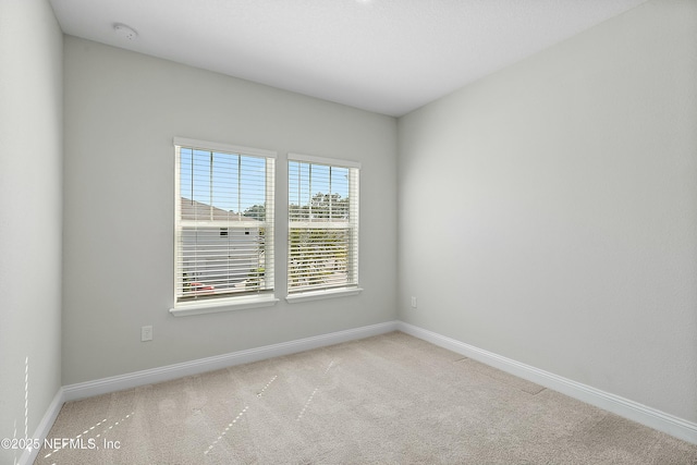 empty room with baseboards and carpet floors