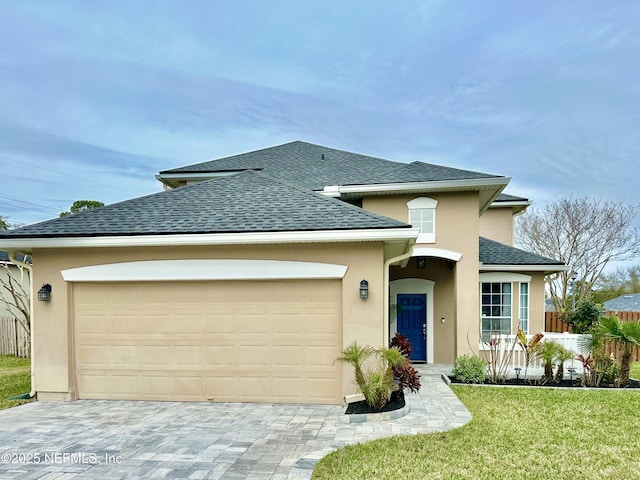 view of front of property with a garage, a shingled roof, fence, decorative driveway, and stucco siding