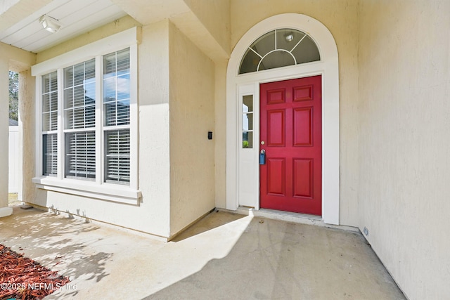 entrance to property with stucco siding