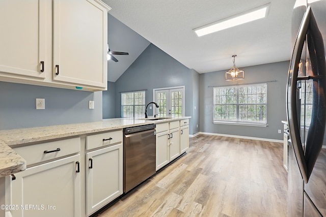 kitchen with stainless steel appliances, a sink, white cabinetry, a ceiling fan, and light wood-type flooring