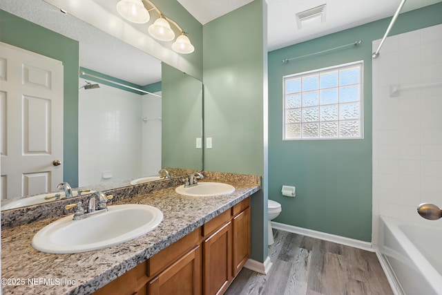 bathroom with toilet, visible vents, and a sink