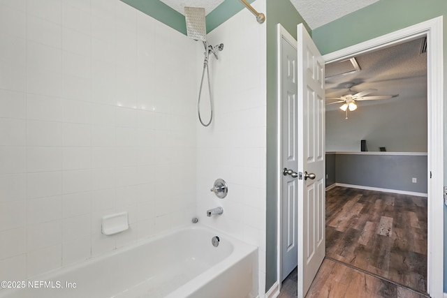 bathroom with  shower combination, a textured ceiling, and wood finished floors