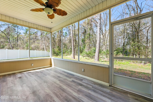 unfurnished sunroom featuring a wealth of natural light and ceiling fan