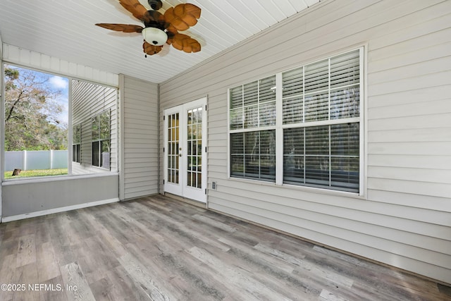 unfurnished sunroom featuring ceiling fan