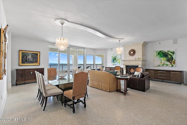 dining room with a fireplace and a chandelier