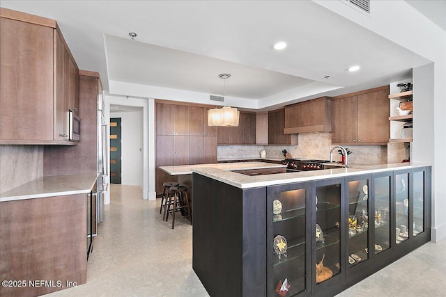 kitchen featuring visible vents, decorative backsplash, custom exhaust hood, light countertops, and open shelves