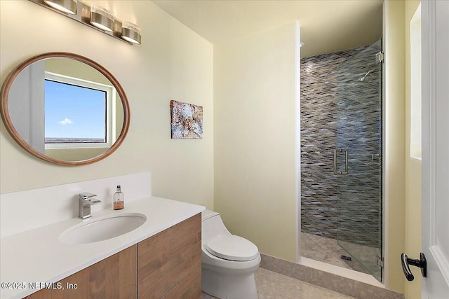 bathroom with a shower stall, toilet, and vanity