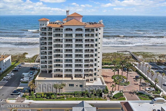 view of building exterior featuring a view of the beach and a water view