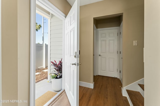 interior space with baseboards and wood finished floors